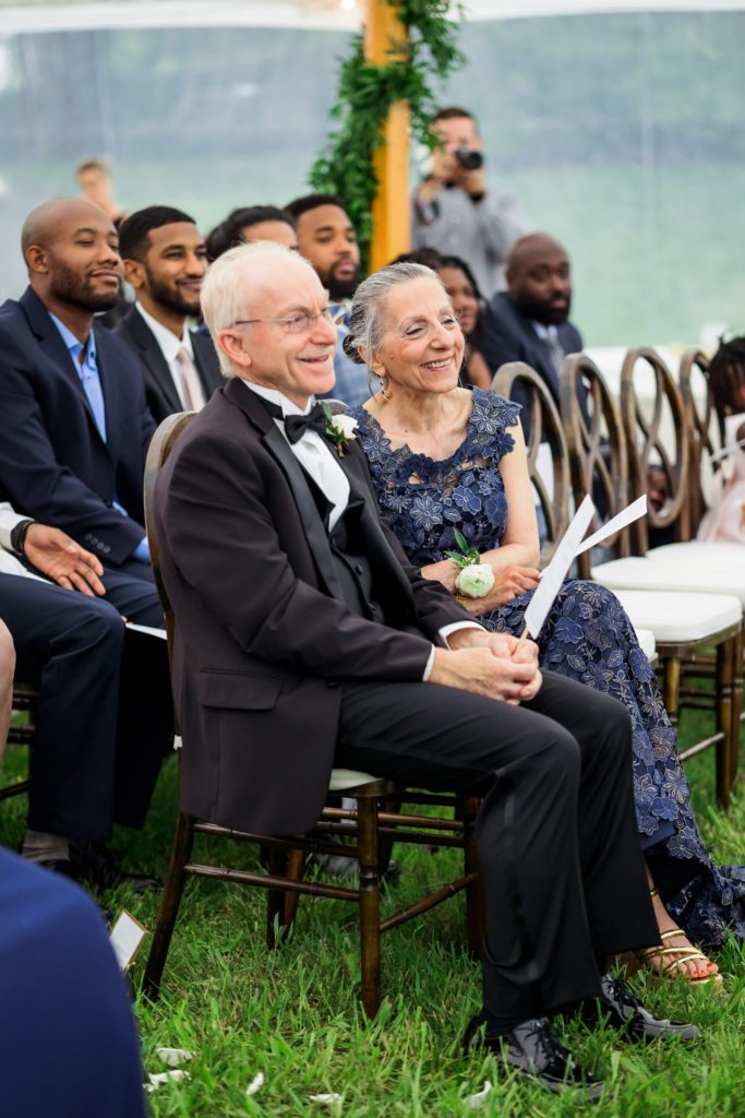 bride's family sitting and smiling during ceremony