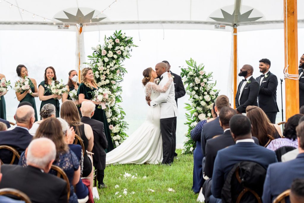 bride and groom kissing as husband and wife after wedding ceremony