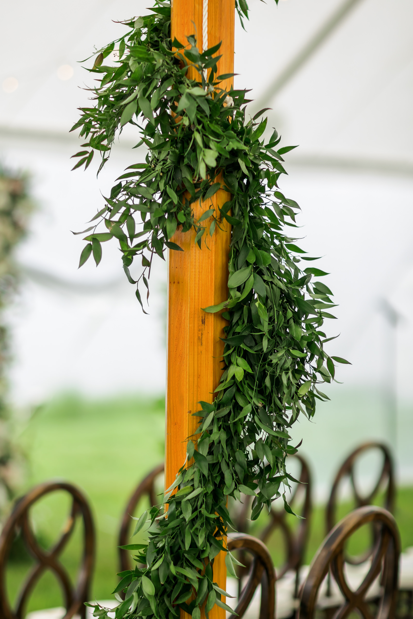 wooden poles with greenery around