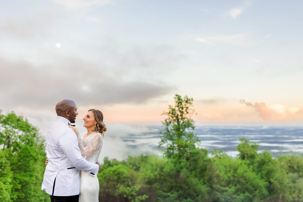 bride and groom hugging while overlooking the view of Montalto