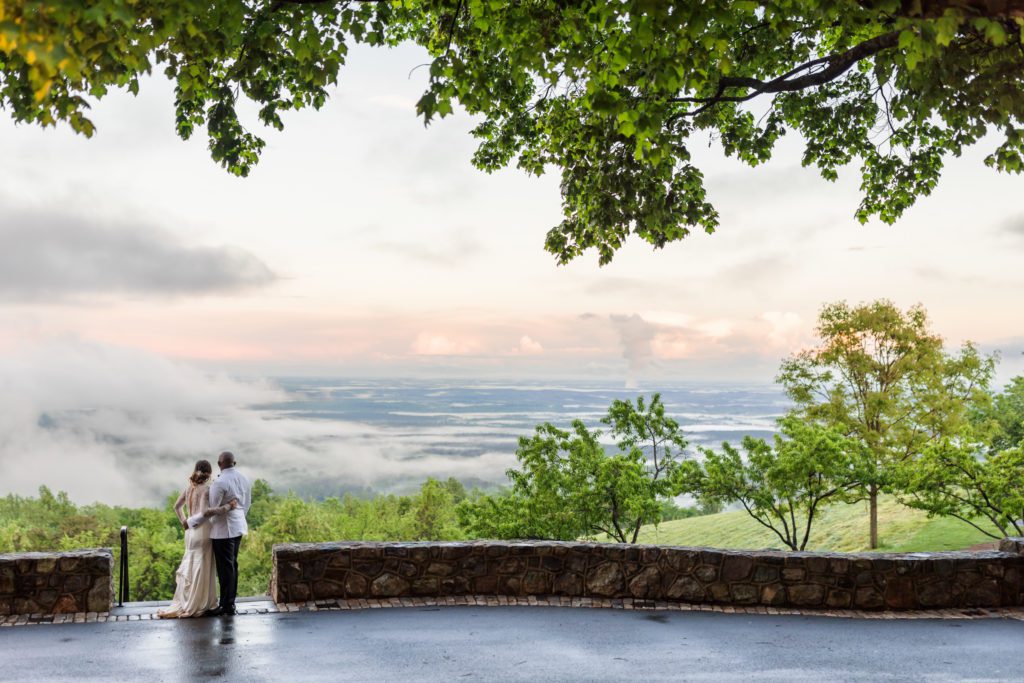 couple embracing and looking over the mountaintop