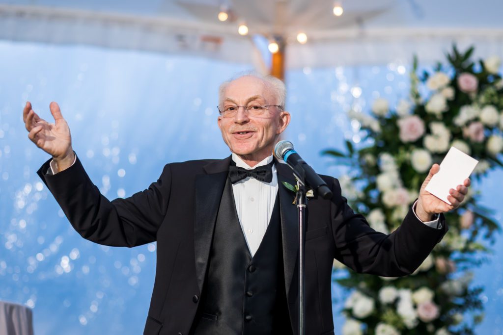 wedding guest giving toast at evening reception