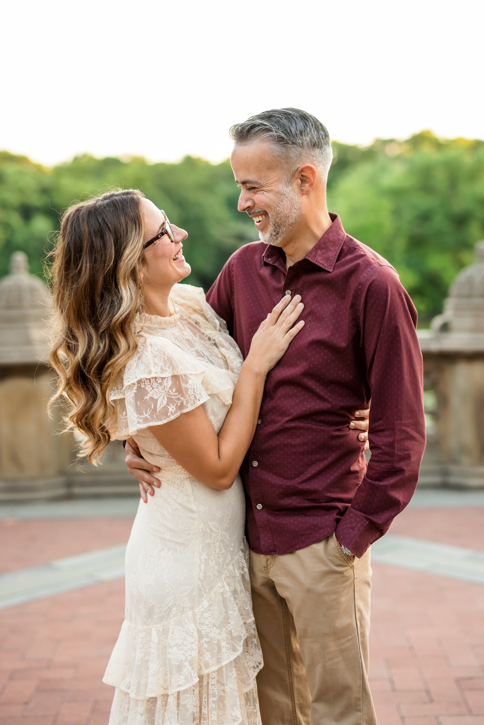 man and woman embracing and smiling at one another during couples photoshoot