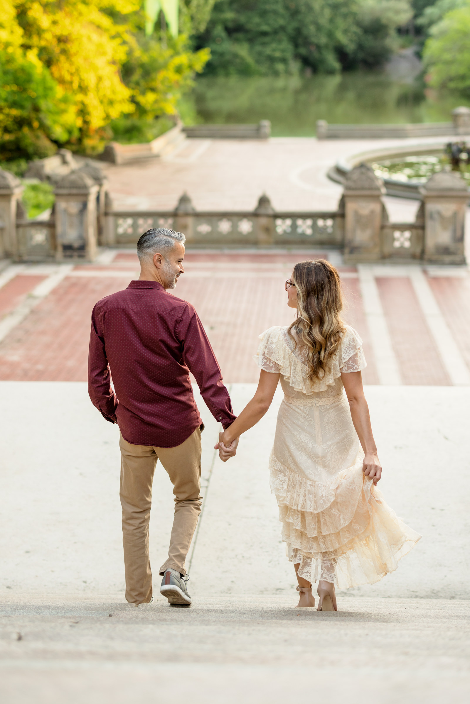 couple walking down Bethesda Terrace during outdoor engagement session
