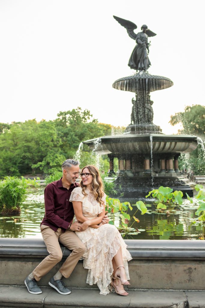 couple sitting in front of fountain at Bethesda Terrace