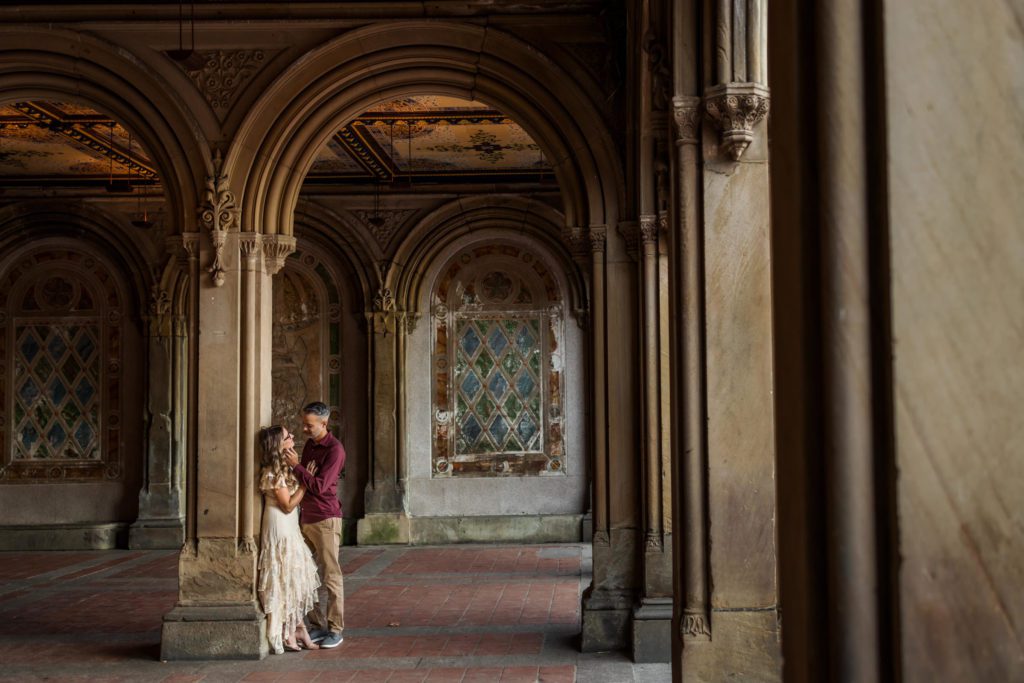 man and woman embracing at Bethesda Terrace engagement session