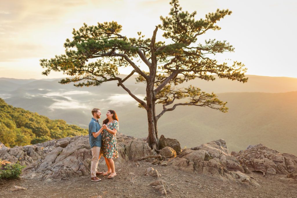 newly engaged couple dancing at top of Ravens Roost