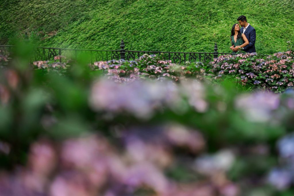 man and woman embracing from distance in gardens