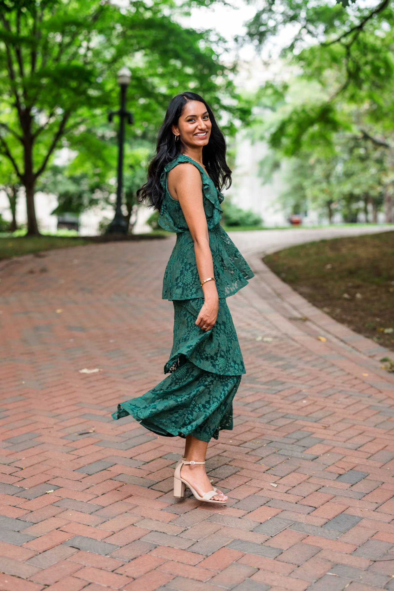 woman twirling emerald green dress around at richmond engagement session