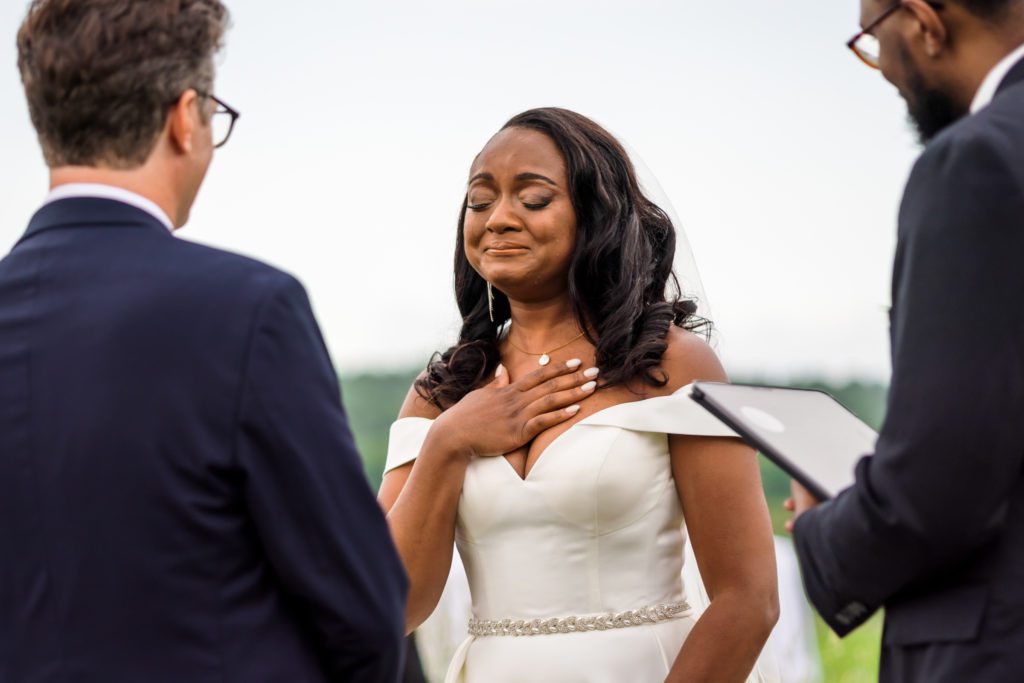 bride crying as she listens to groom's vows at Lexington backyard wedding