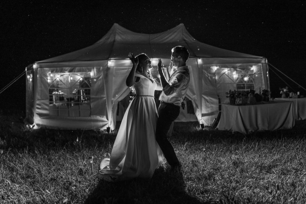 bride and groom dancing together after reception