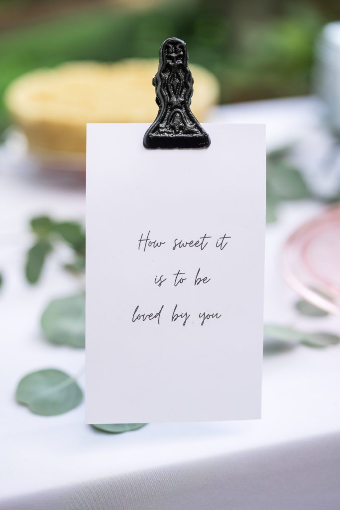 a white card with 'how sweet it is to be loved by you' typed on it