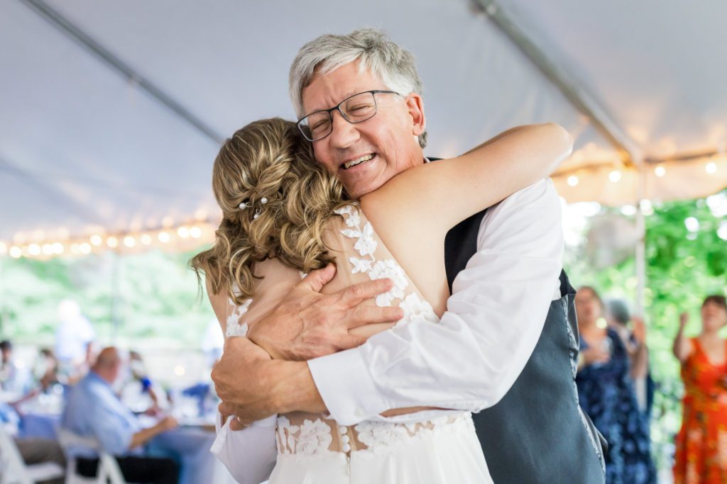 bride embracing father after father-daughter dance
