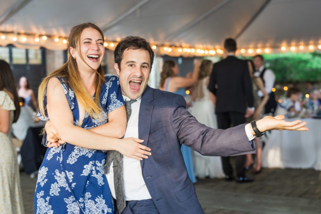 wedding guests dancing and having fun at outdoor reception