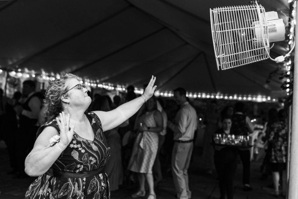 black and white portrait of wedding guest dancing at reception