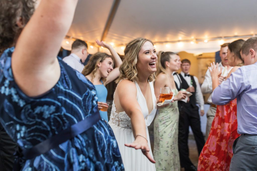 bride dancing with wedding guests at reception
