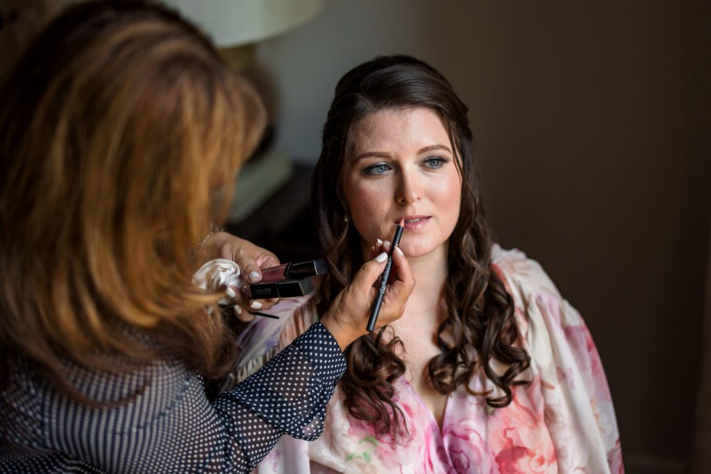 Kate getting makeup done before putting on wedding dress
