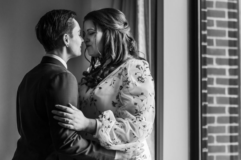 couple embracing and kissing before wedding ceremony after first look