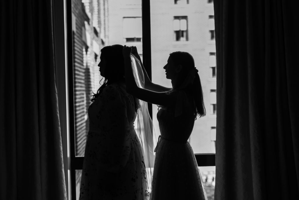 bride getting veil placed on her head before four seasons dc wedding