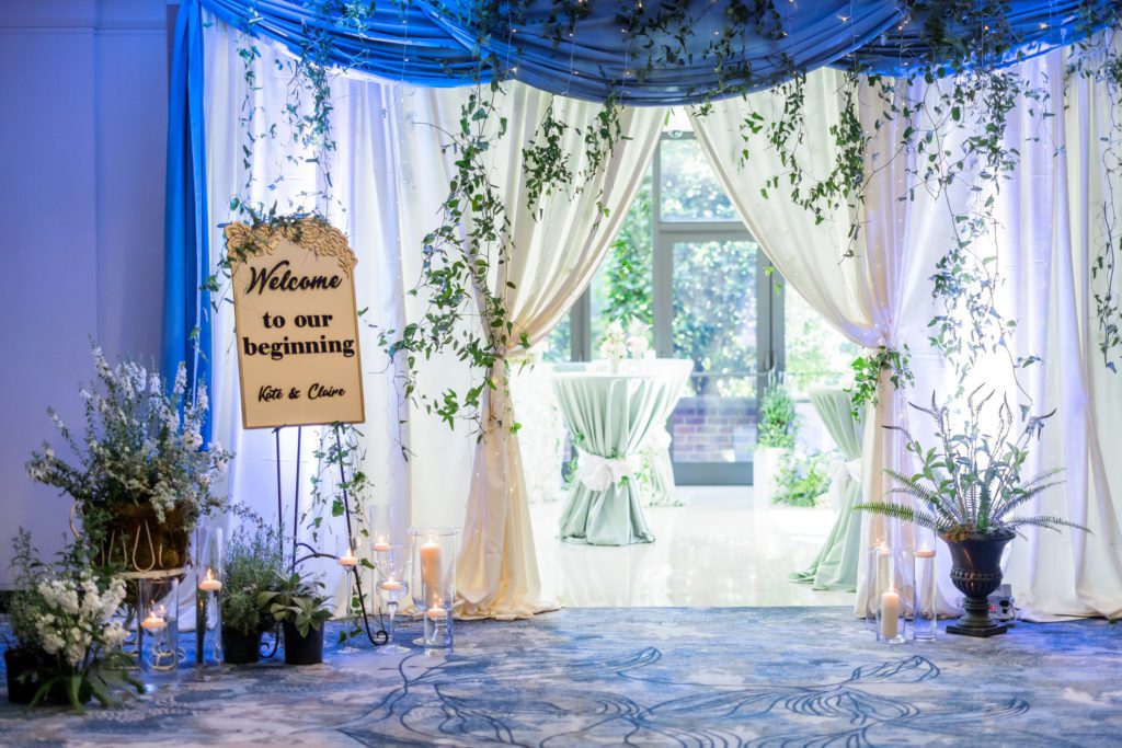 curtains and ceremony decor with greenery and beautiful lighting