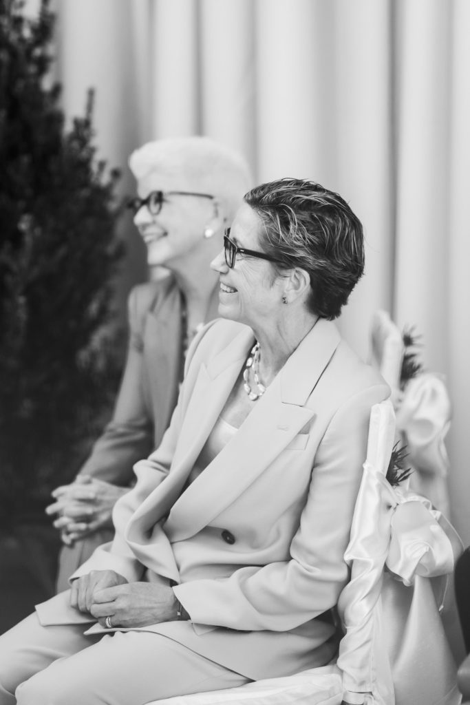 black and white portrait of family members watching ceremony