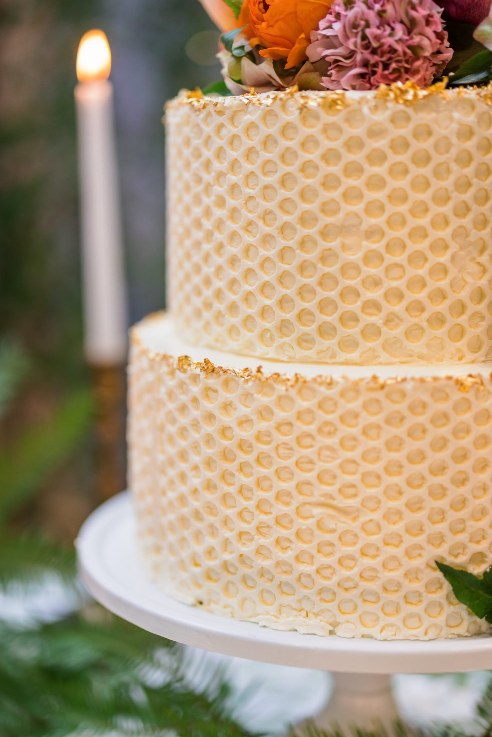 close up of honeycomb design on two tiered white cake