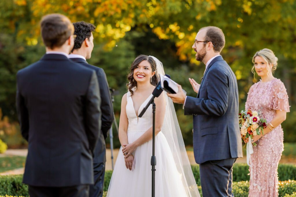 bride smiling at groom during wedding ceremony