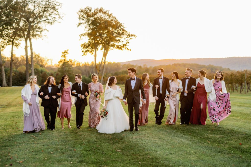 bride and groom walking with wedding party after Keswick Vineyards wedding