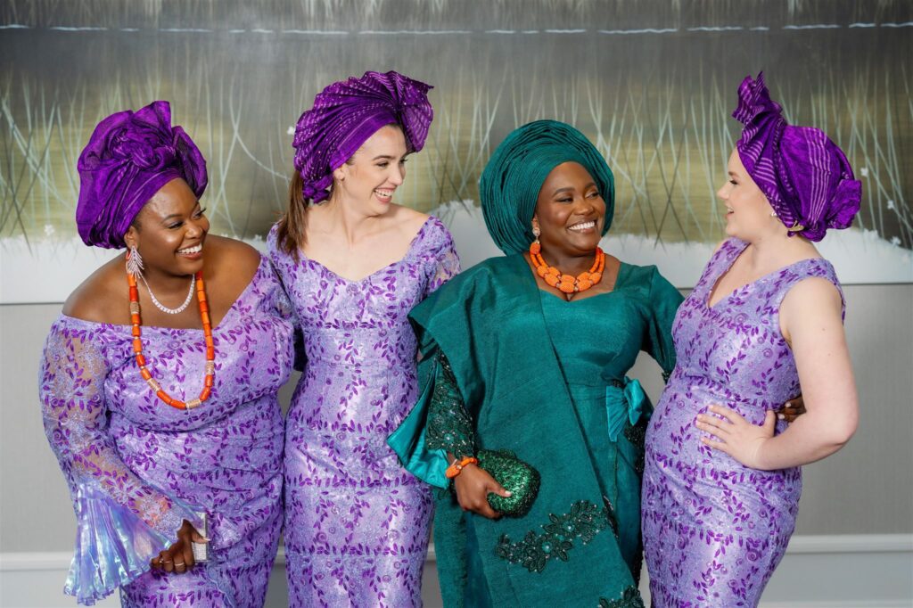 Bride standing with bridesmaids in second outfit of the wedding celebrations