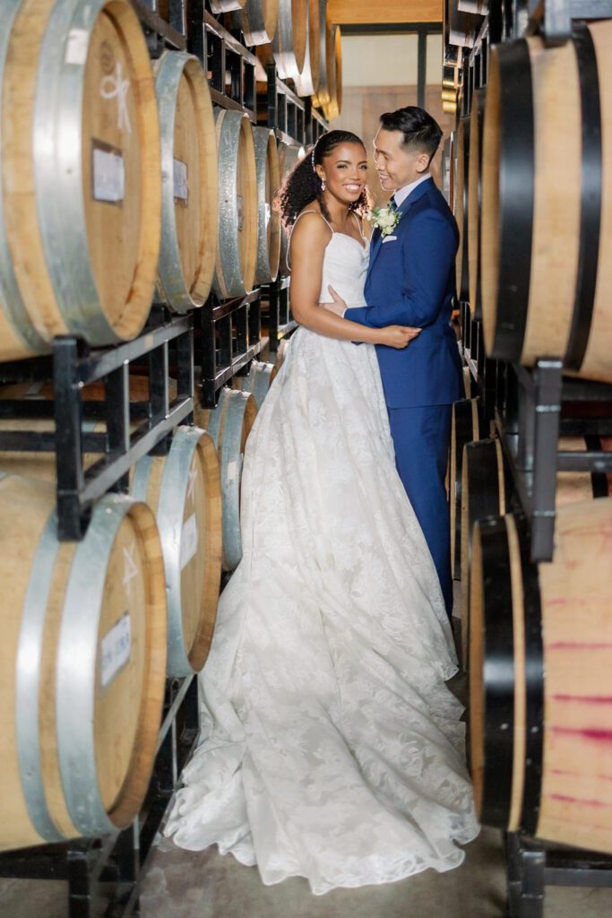 Couple laughing during wedding portraits before wedding ceremony at winery