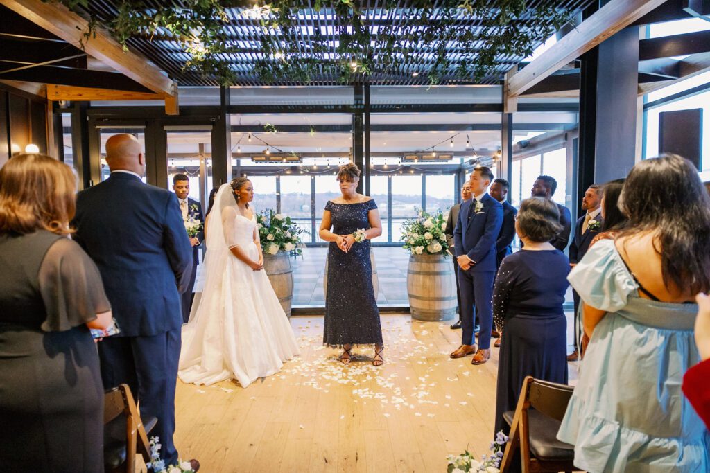 Woman wearing sparkly blue dress stands at alter
