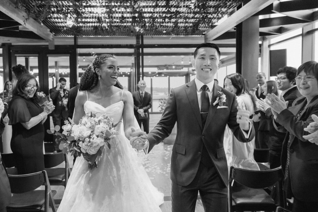 Couple walking out of ceremony as husband and wife