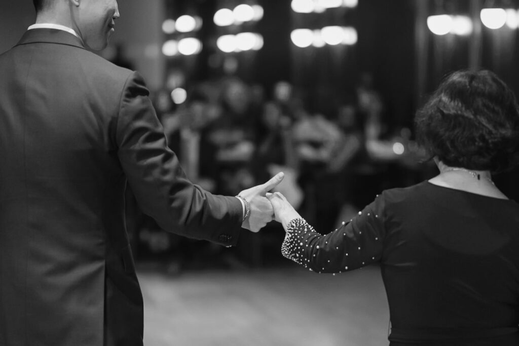 groom leading his mother to dance floor for mother-son dance
