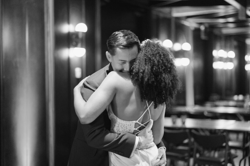 Groom hugging bride after evening reception at District Winery